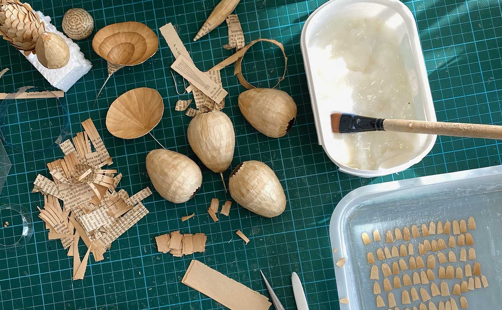 The paper shreds, bulbs, flowers, and paste used to create Levy’s “fantasy plants.”