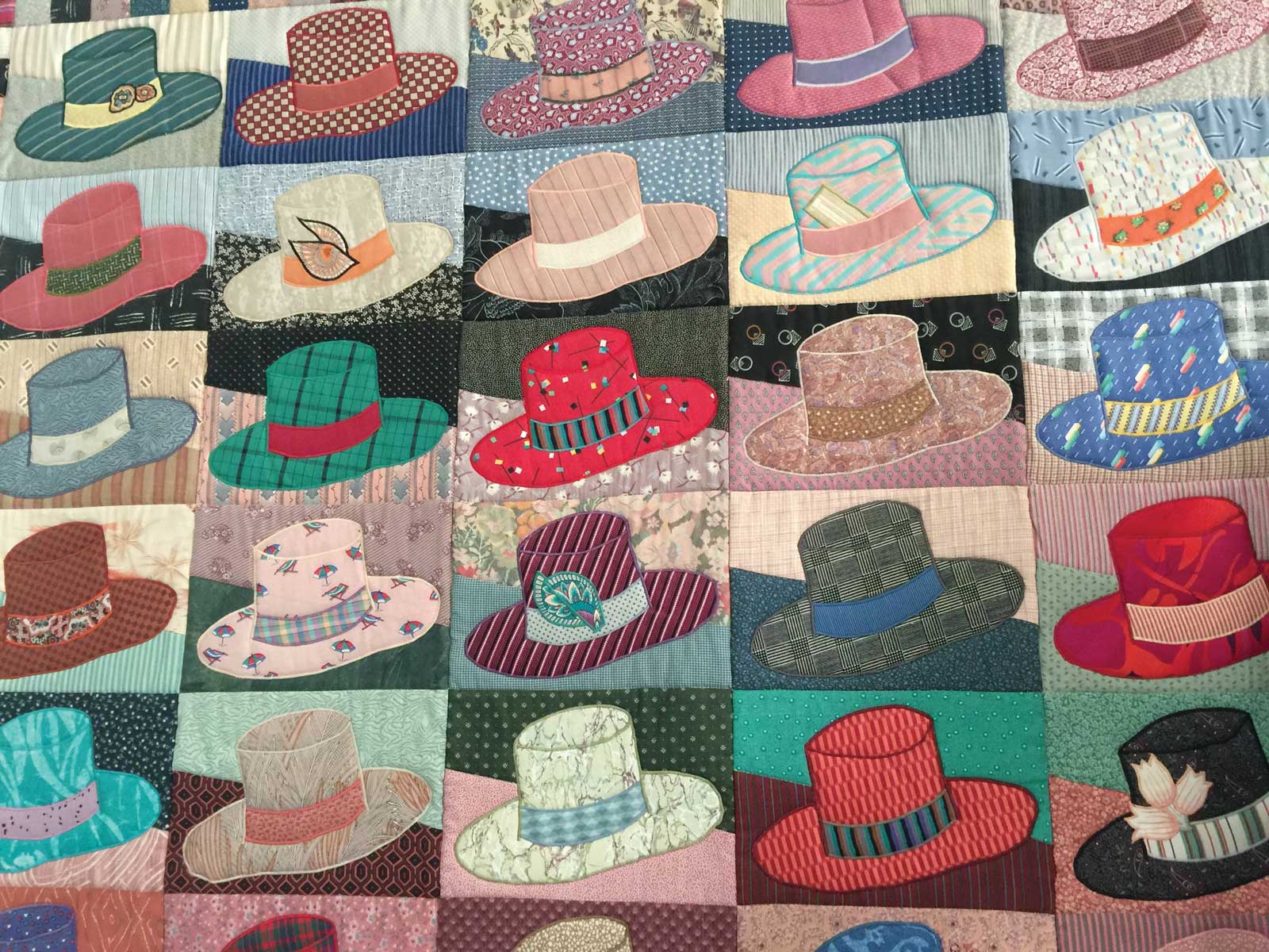 A hat-themed quilt is one of the quirky decorative elements in Wolfe's New York City apartment.