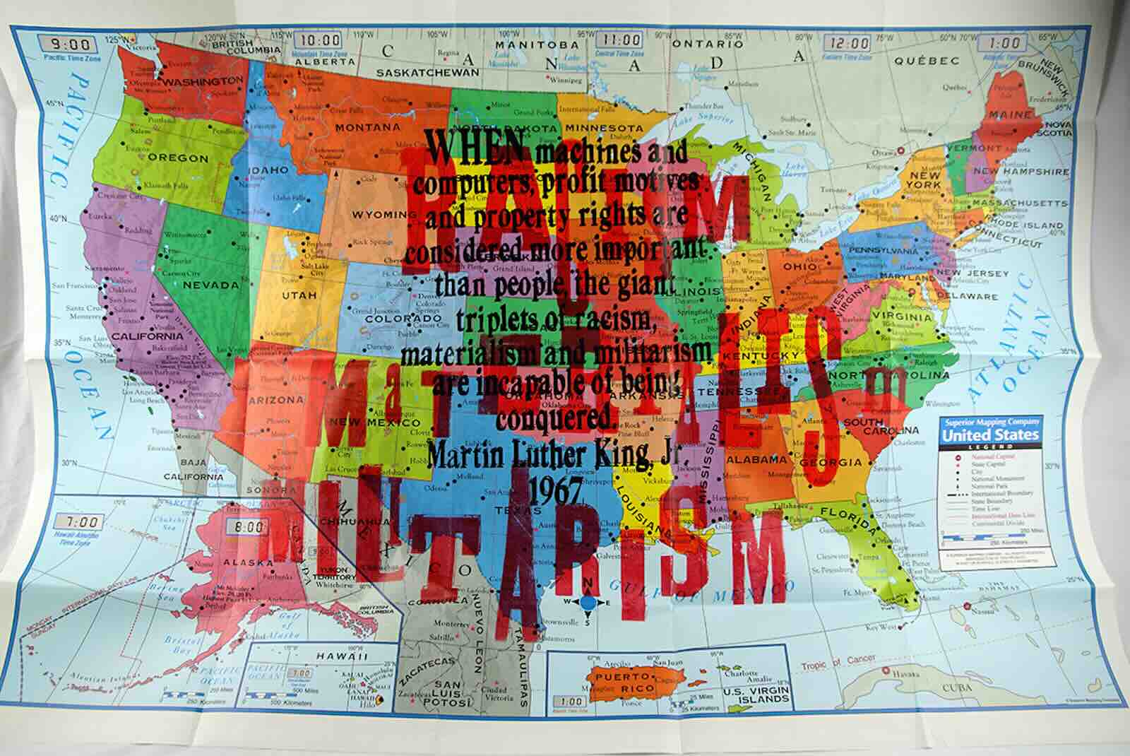 Amos Paul Kennedy, Jr.  Racism/Materialism/Militarism, c. 2020 . Folded map of the United States and its territories, designated into time zones. Overprinted in wood type is as a first layer "Racism/Materialism/Militarism," overtly linking these three ideologies and their inextricability from American history and consciousness. Above these is a statement by Martin Luther King, Jr.: "When machines and computers, profit motives and property rights are considered more important than people, the giant triplets