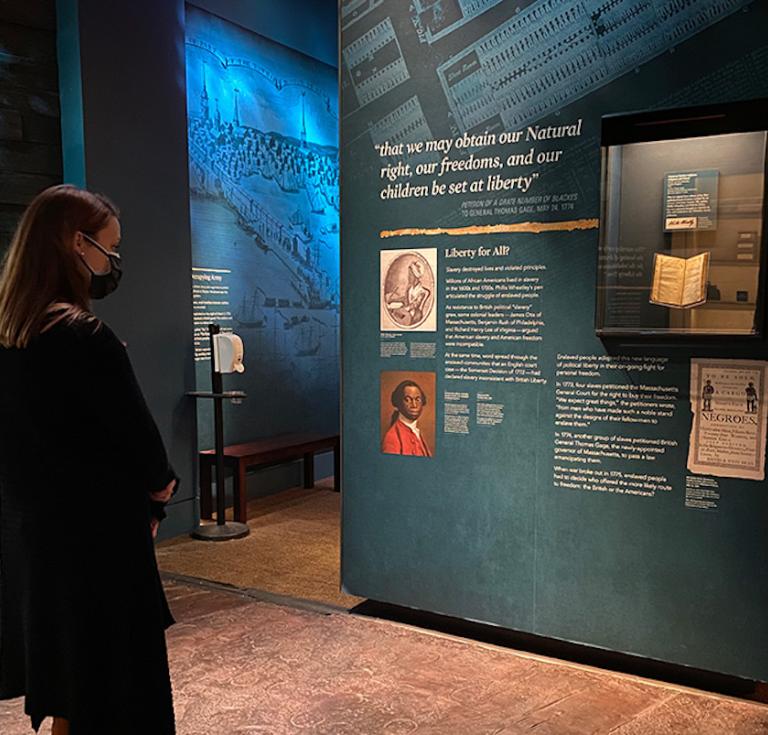 Museum guest looking at Wheatley book exhibit
